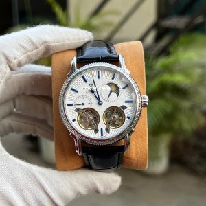 Patek Philippe watch with a white dial, two tourbillon-style open heart escapements, and a black leather strap Master Grade