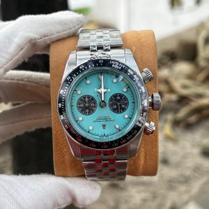 Tudor Black Bay Chrono watch with a turquoise or "flamingo blue" dial and a stainless steel bracelet. Master Grade