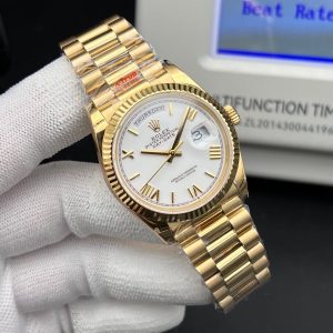Rolex Day-Date 40 reference 228238 in gold with a fluted bezel, a white dial, and Roman numeral hour markers. Swiss 1:1