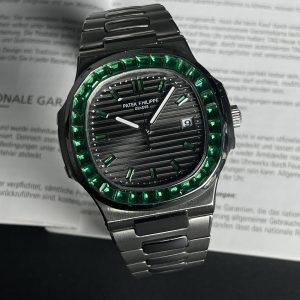 Patek Philippe Nautilus Ref. 5711/113P-001with a black dial and a bezel set with baguette-cut emeralds.  Euro Grade
